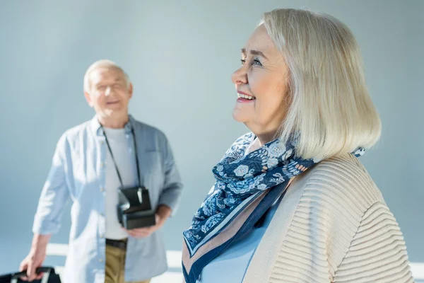 Senior couple with retro camera — Stock Photo