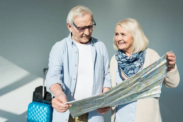 Senior couple with traveling map — Stock Photo