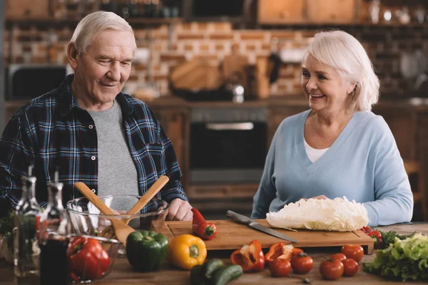 Senior couple cooking together — Stock Photo
