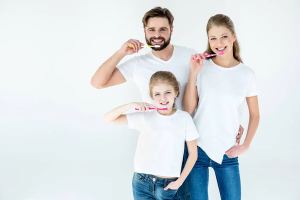 Family holding toothbrushes — Stock Photo