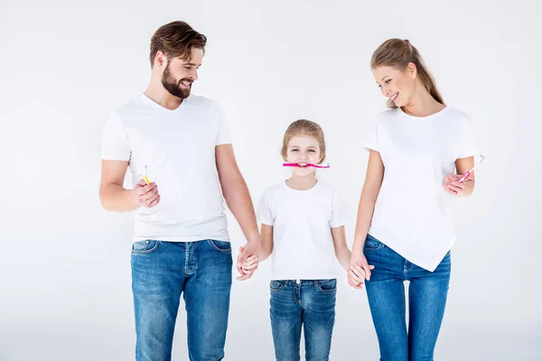 Family holding toothbrushes — Stock Photo