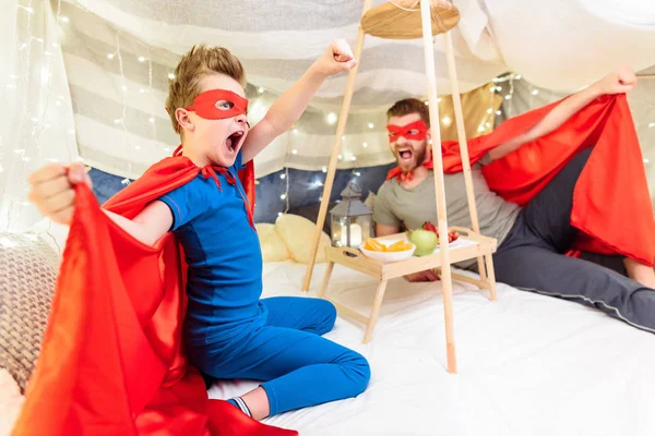 Father and son in superhero costumes — Stock Photo