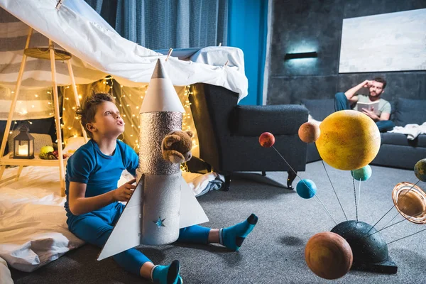 Boy playing with toy rocket — Stock Photo