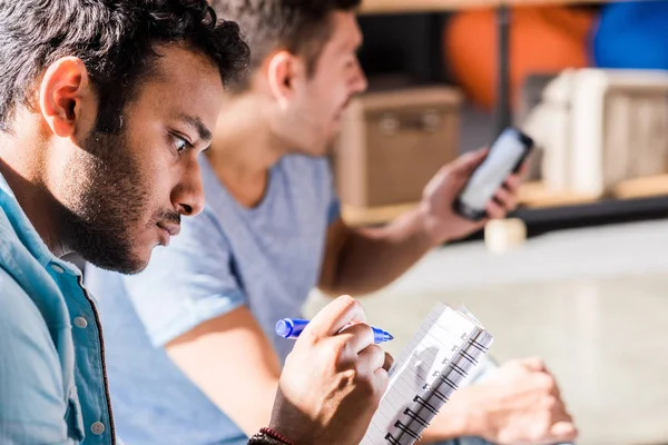 Men writing in notepad — Stock Photo