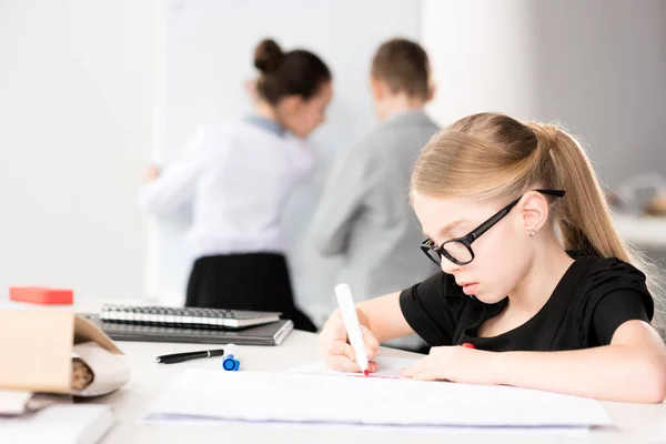 Kleines Mädchen sitzt am Tisch — Stockfoto