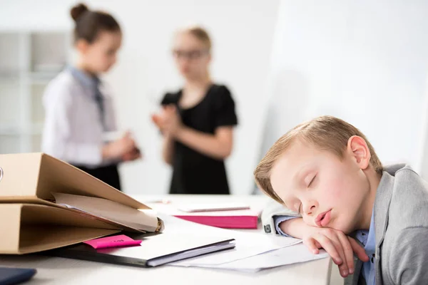 Little boy dreaming on table — Stock Photo