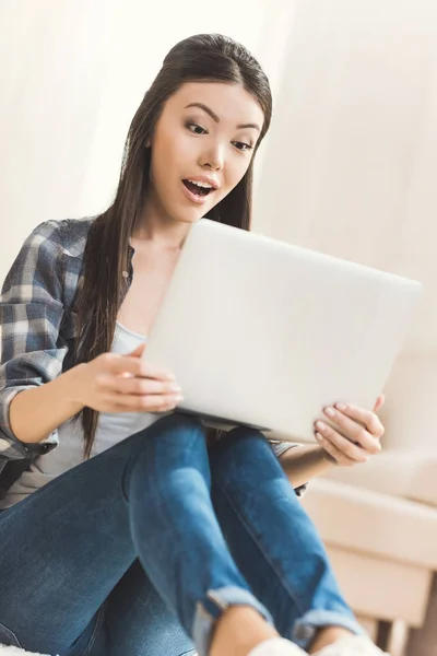 Donna seduta sul pavimento e al lavoro sul computer portatile — Foto stock