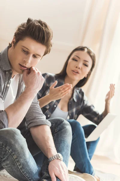 Couple arguing while sitting on floor — Stock Photo