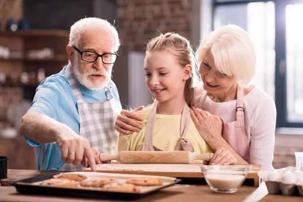 Family kneading dough — Stock Photo