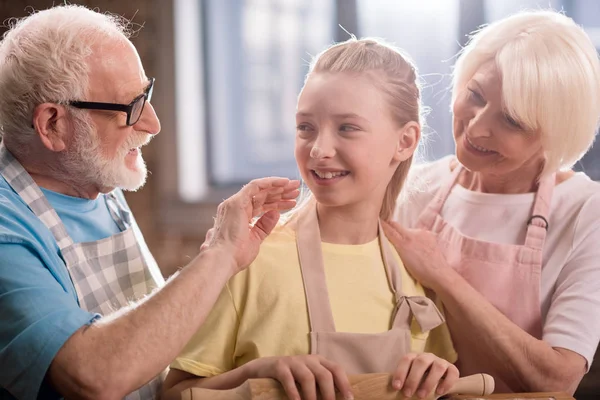 Family kneading dough — Stock Photo