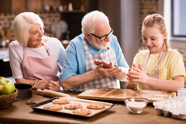 Family kneading dough — Stock Photo