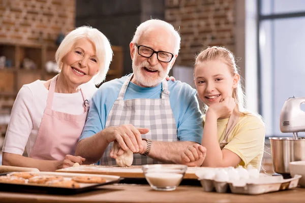 Family kneading dough — Stock Photo