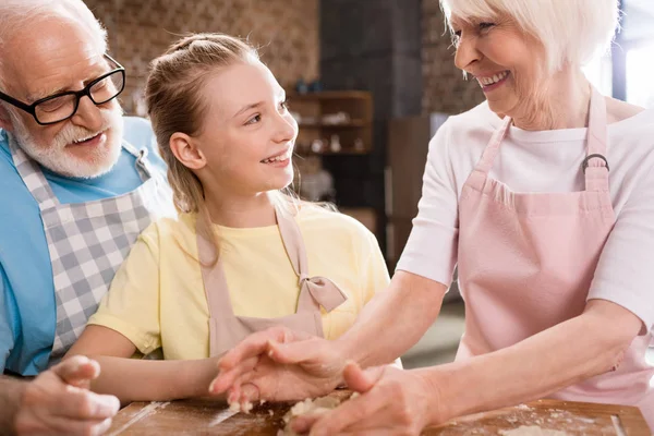 Family kneading dough — Stock Photo