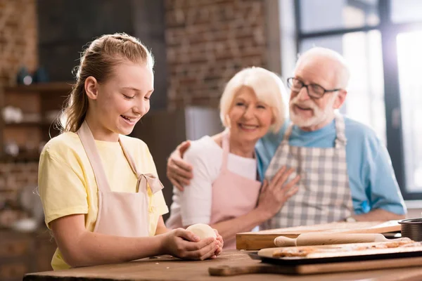 Family kneading dough — Stock Photo