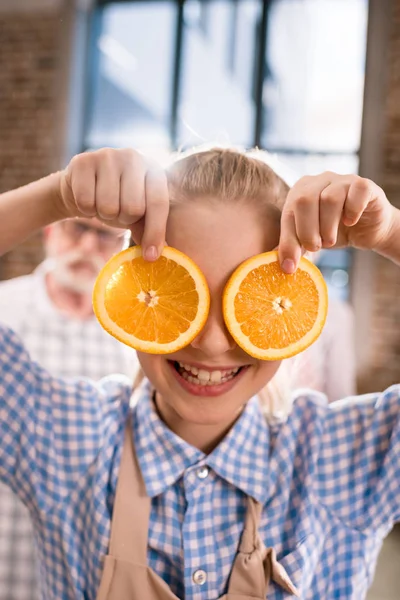 Girl holding orange slices — Stock Photo