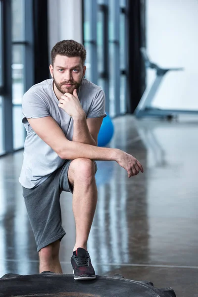Confident man leaning on tyre — Stock Photo