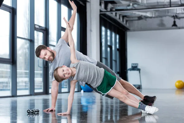 Man and boy doing plank exercise — Stock Photo