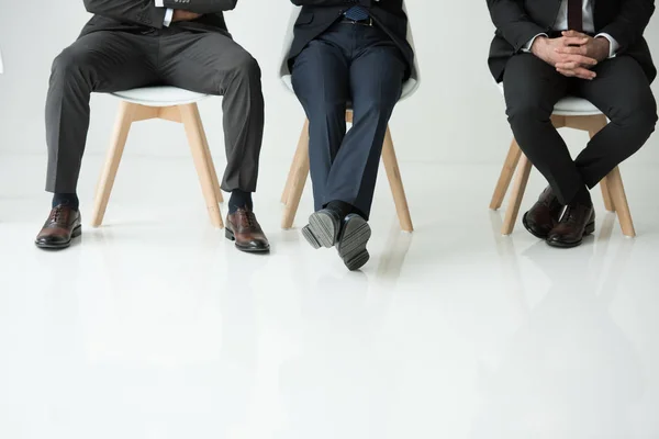 Businessmen sitting on chairs — Stock Photo