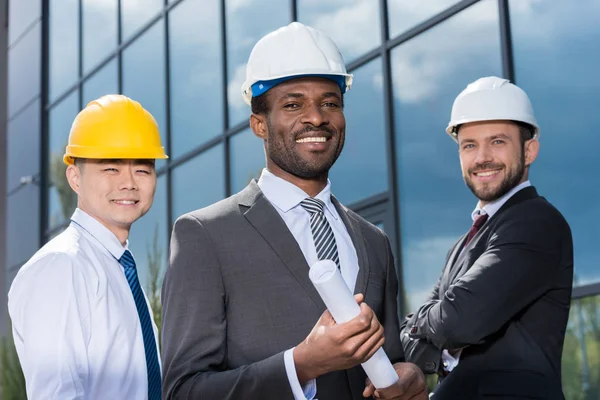 Professional architects in hard hats — Stock Photo