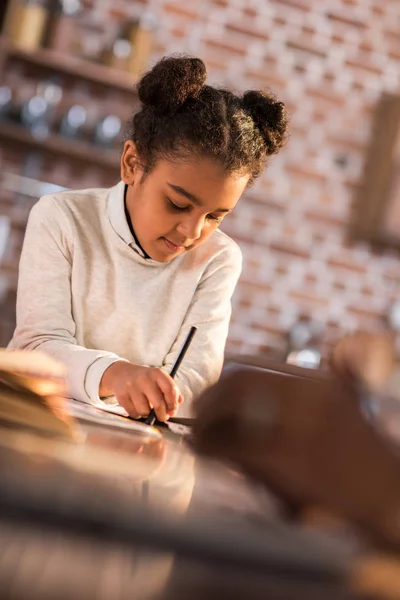 Little girl doing homework — Stock Photo