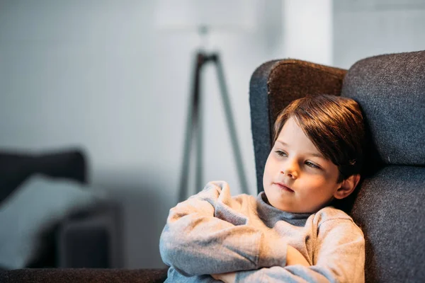 Boy sitting in armchair — Stock Photo