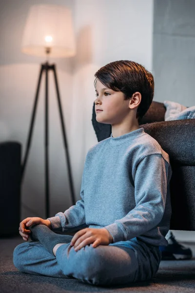 Boy sitting in lotus pose — Stock Photo