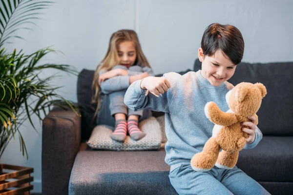 Junge schlägt Teddybär — Stockfoto