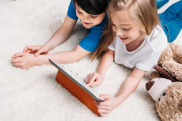 Little boy and girl with digital tablet — Stock Photo