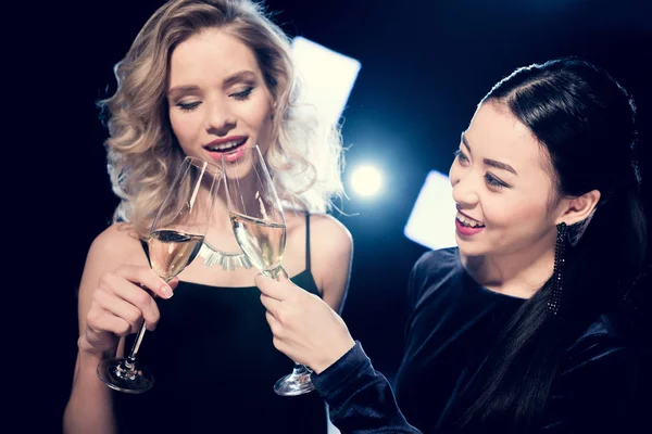 Multicultural glamour girls with champagne — Stock Photo