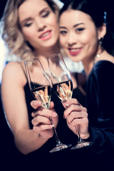 Multicultural glamour girls with champagne — Stock Photo