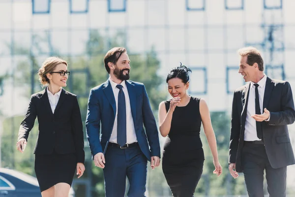 Multiethnic businesspeople walking in city — Stock Photo