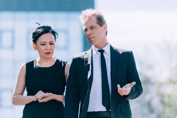 Multiethnic business colleagues walking and talking — Stock Photo