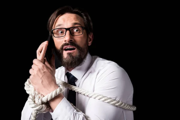 Tied businessman holding smartphone — Stock Photo