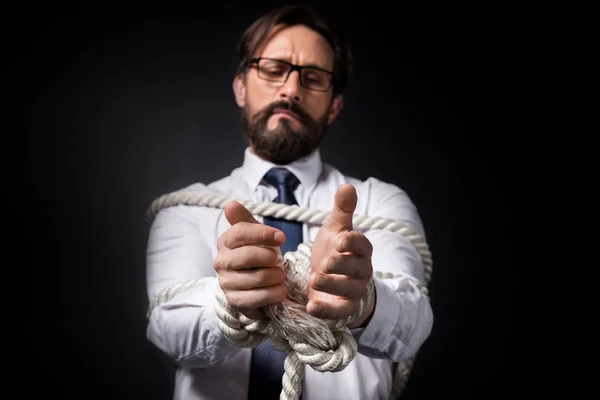 Businessman tied with rope — Stock Photo