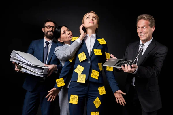 Stressed businesswoman with colleagues — Stock Photo