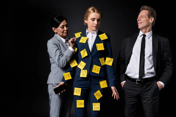 Stressed businesswoman with colleagues — Stock Photo