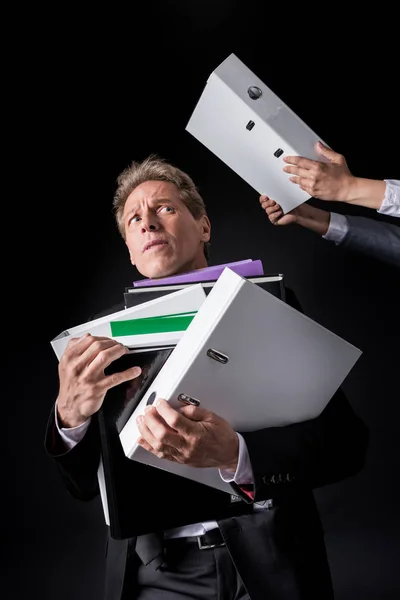 Businessman holding pile of folders — Stock Photo