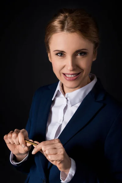 Confident businesswoman holding pencil — Stock Photo