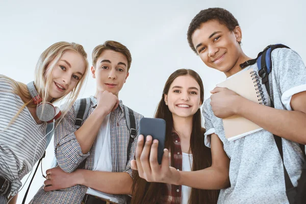 Multicultural teenagers with smartphone — Stock Photo