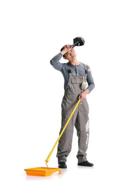 Construction worker with roller brush — Stock Photo