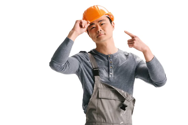 Construction worker ponting at helmet — Stock Photo