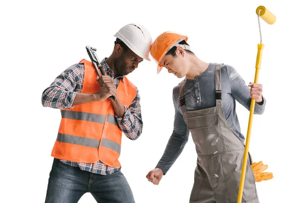 Confrontation of african-american and asian builders — Stock Photo