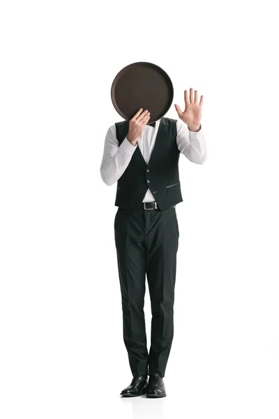 Waiter in suit covering face with tray — Stock Photo