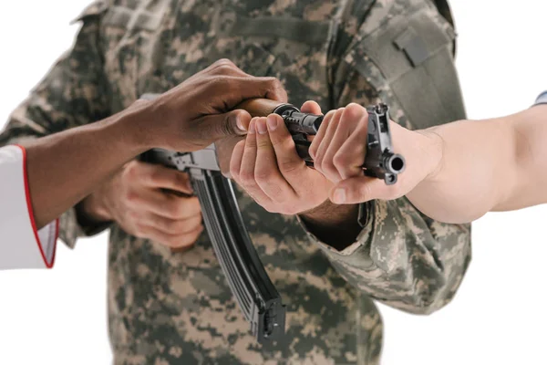 People holding soldiers rifle — Stock Photo