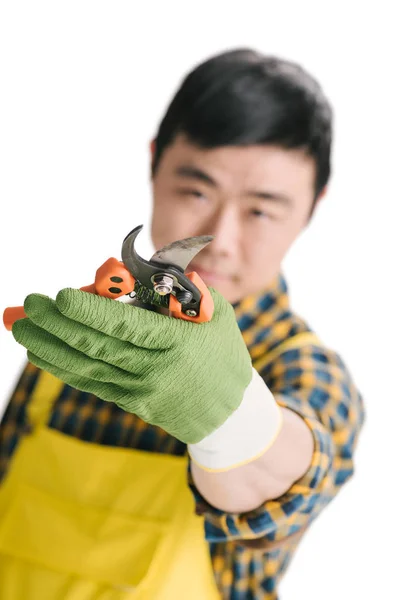 Handsome asian gardener with secateurs — Stock Photo