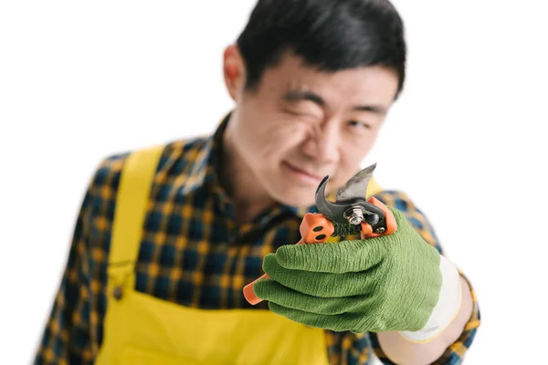 Handsome asian gardener with secateurs — Stock Photo