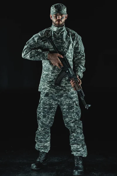 Soldier in military uniform with rifle — Stock Photo