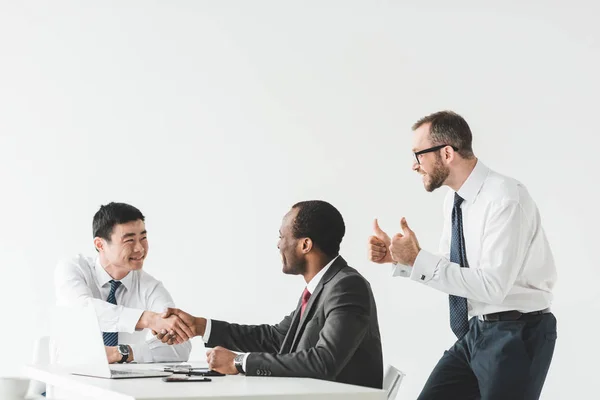 Multiethnic businessmen shaking hands — Stock Photo