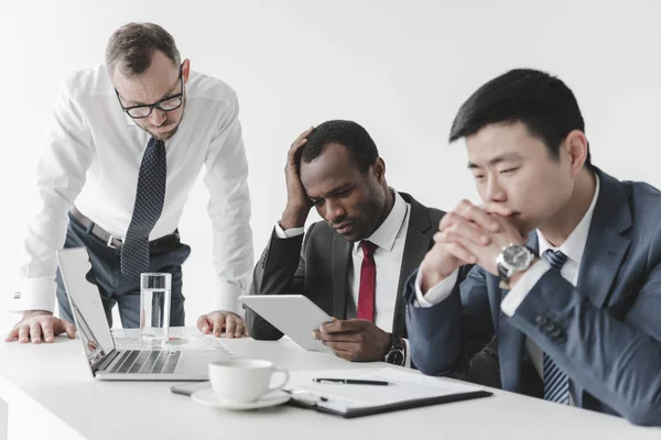 Multicultural businessmen using tablet — Stock Photo