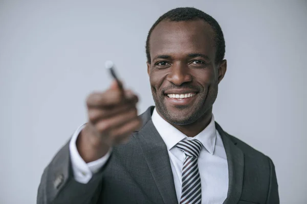 African american businessman with pen — Stock Photo